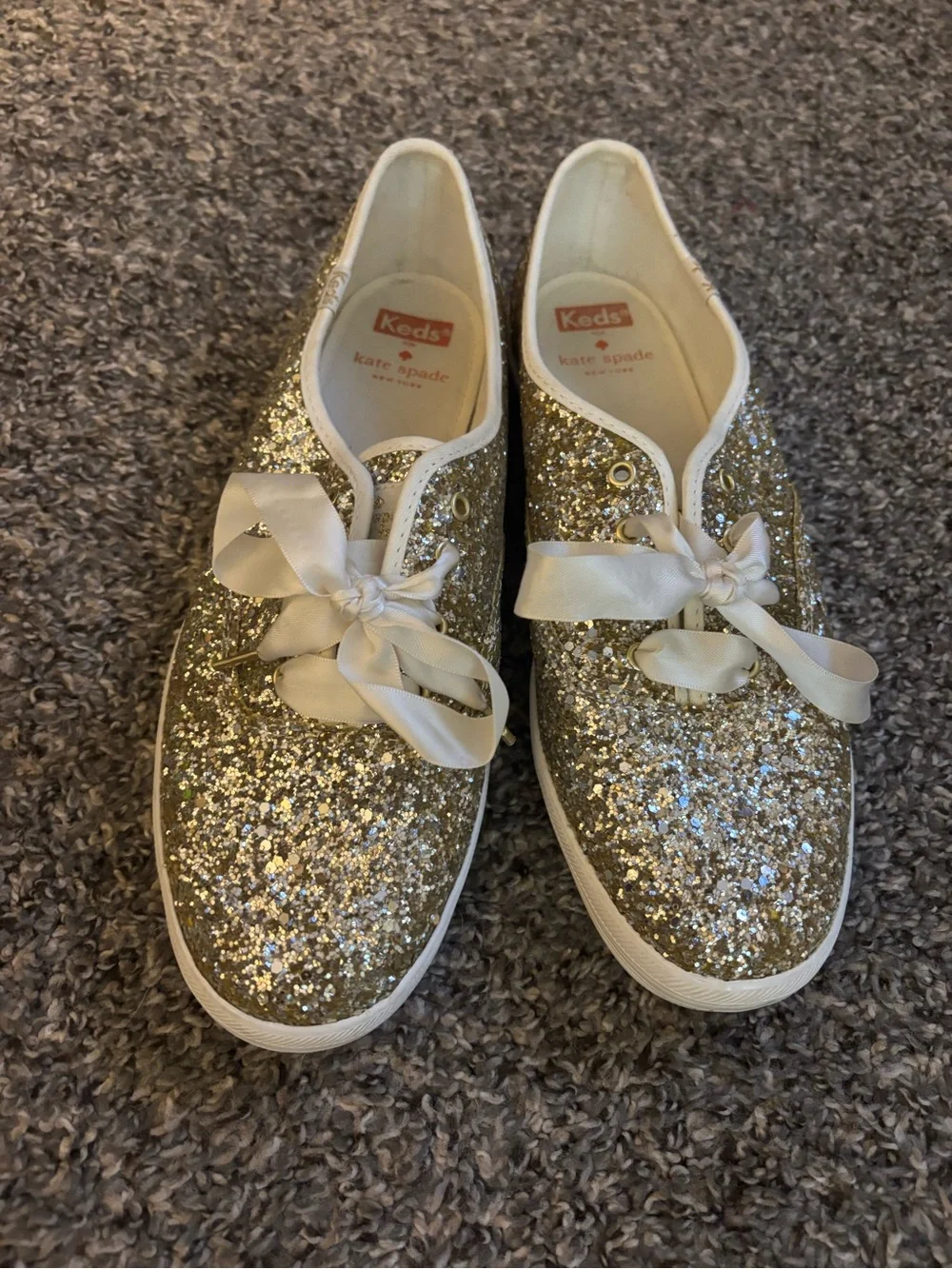 kate spade women’s Gold Glitter Sneakers with Satin Bow